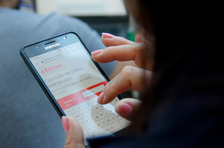 Woman voting with the EVoting platform through a cell phone