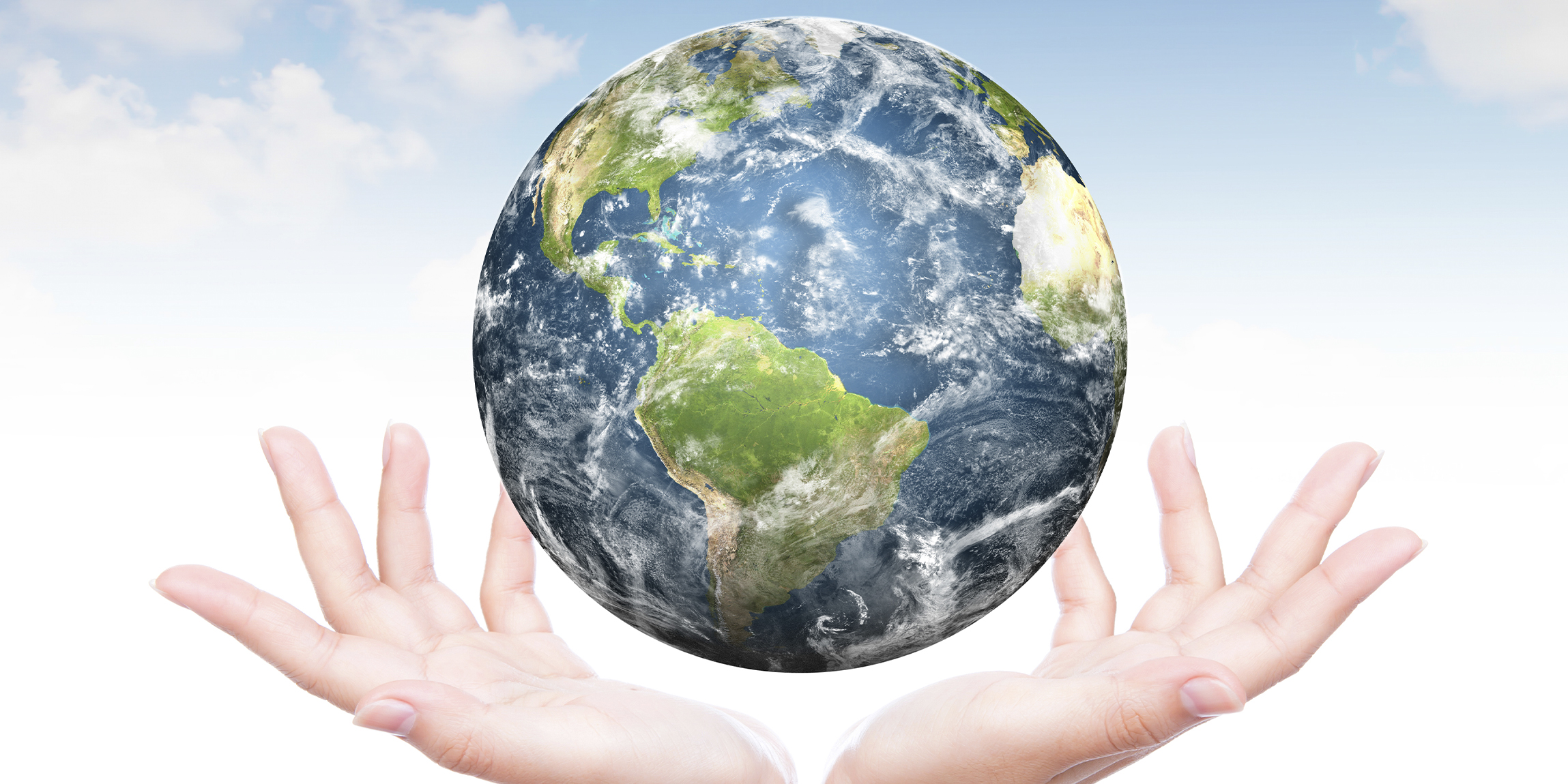 A planet Earth floating on two open hands