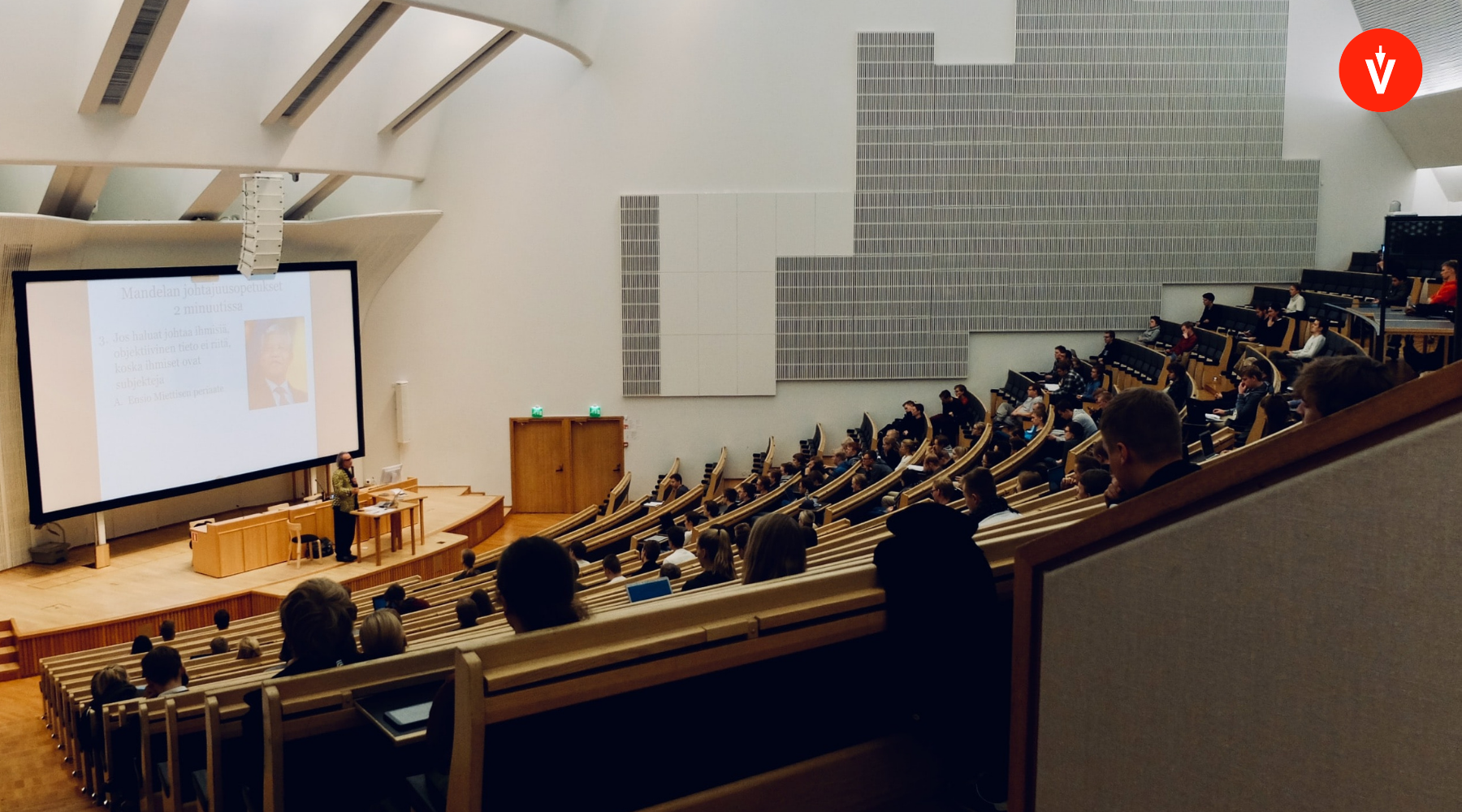 University professor giving a presentation in a room full of students